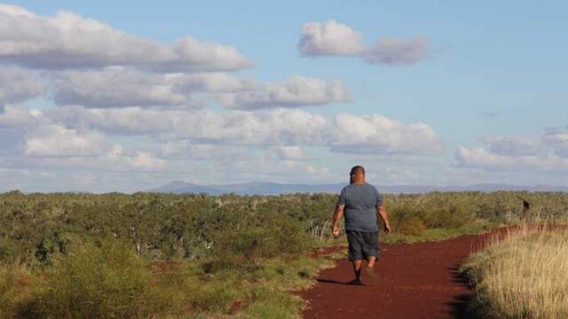 Rodney Adams walking along the cliff with Gamburlarna in the distance